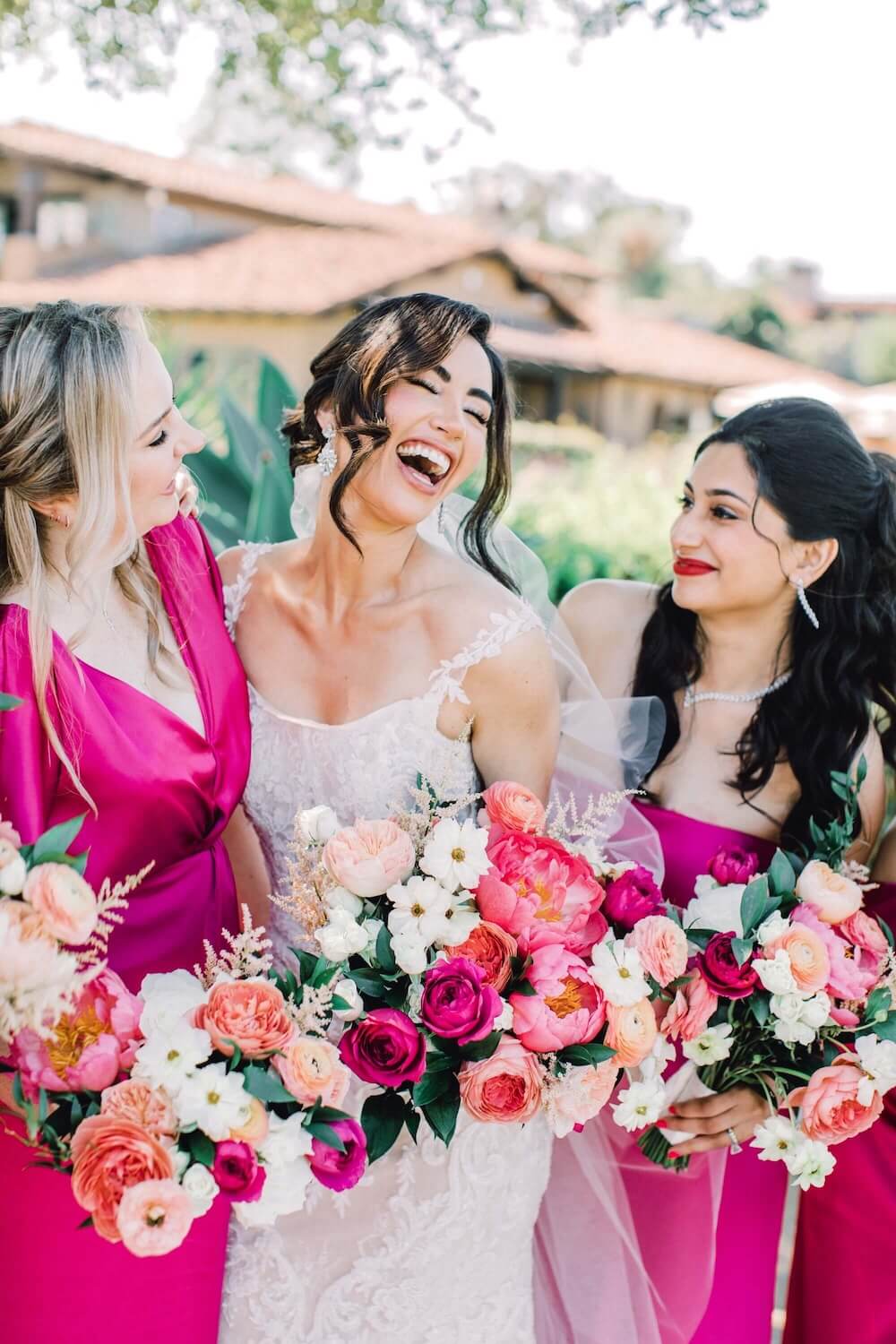bride and bridesmaids with fun vibrant hot pink and orange wedding bouquets