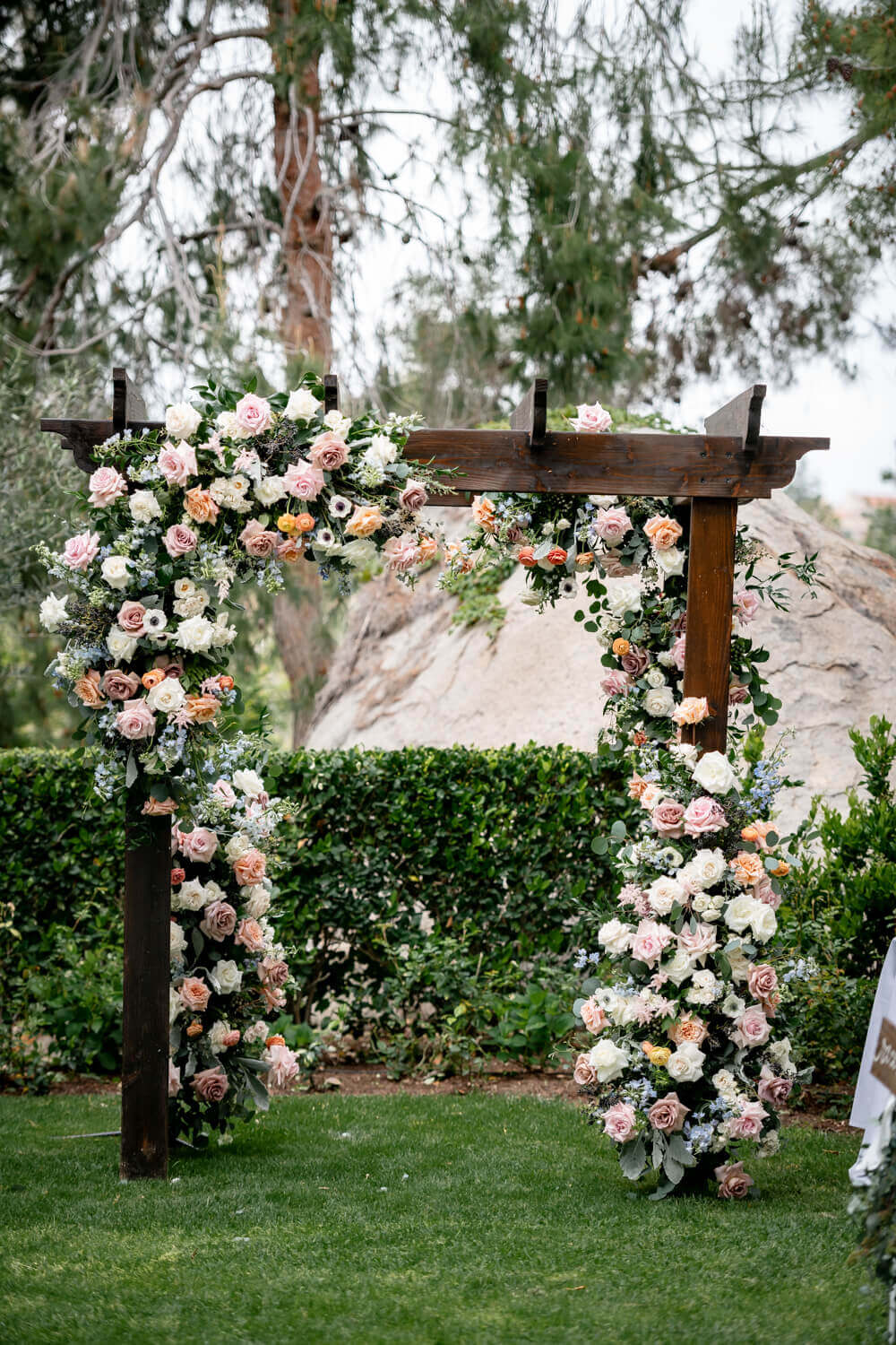 flower arch at san diego wedding ceremony with pale delicate pink flowers