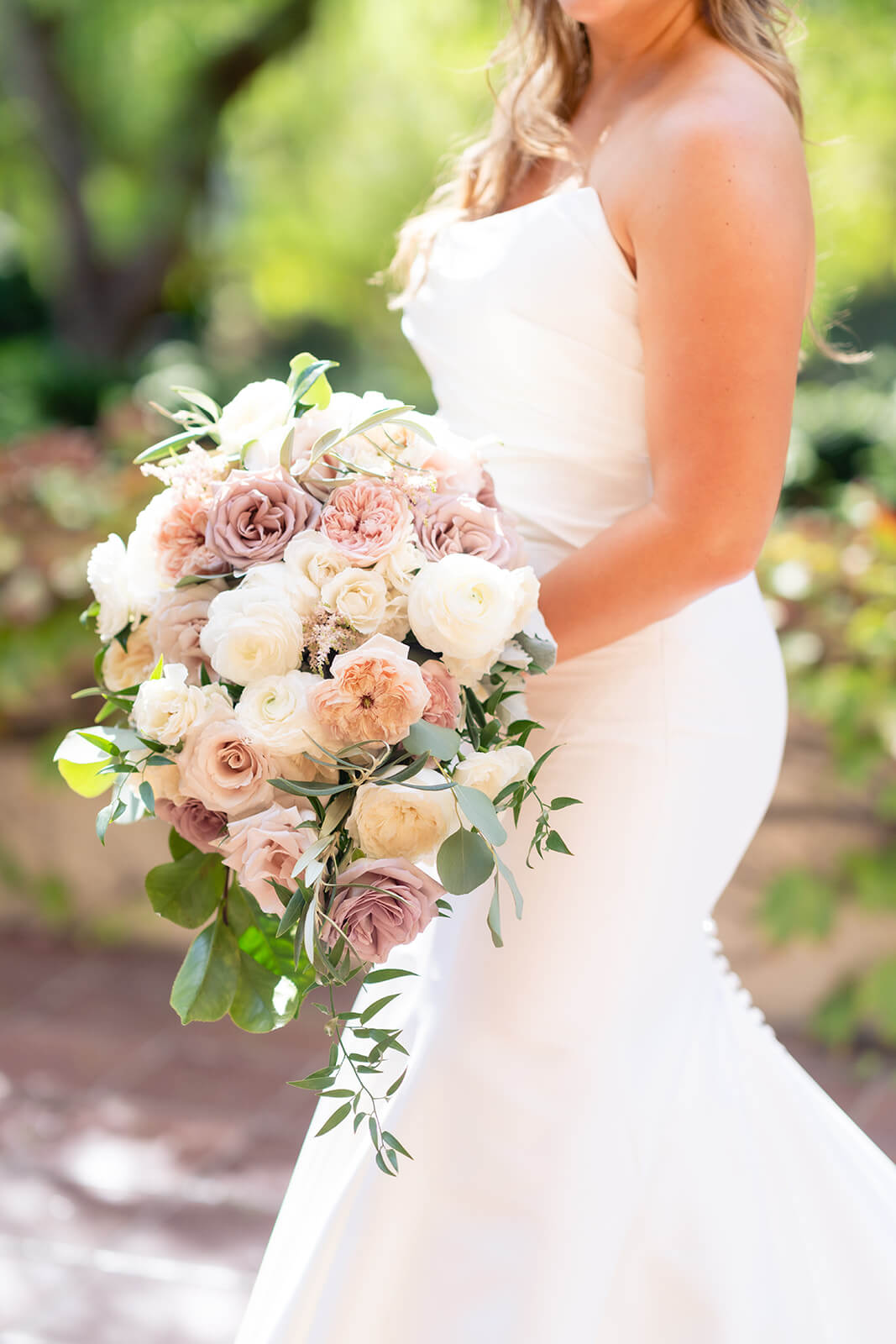 bride holding pale pink and white bridal bouquet