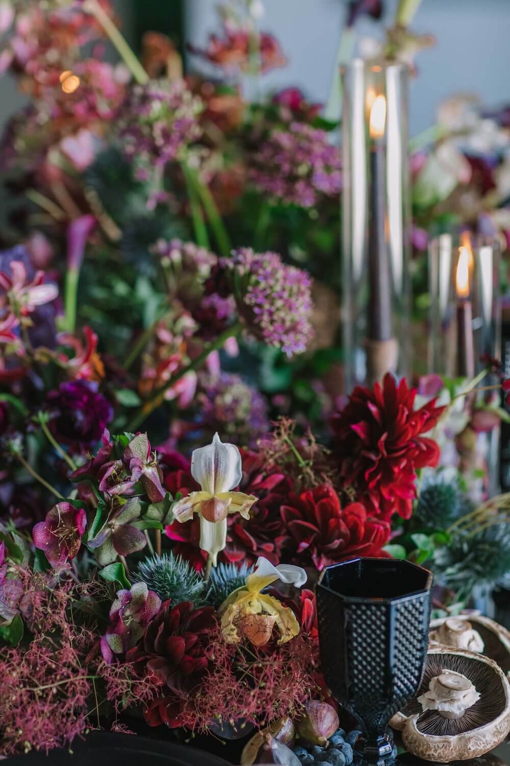 dark red and purple rich and dramatic wedding table flowers